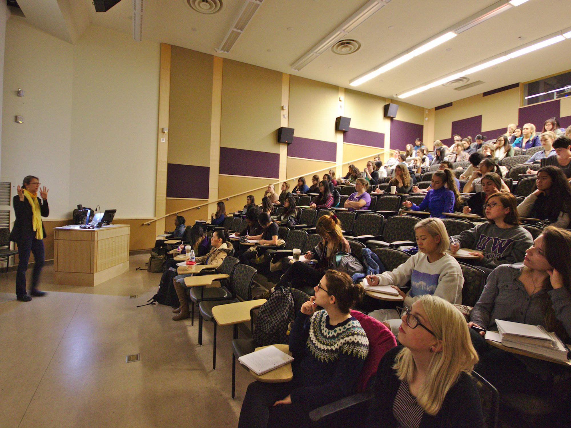 Students observing a lecture in a theater style classroom